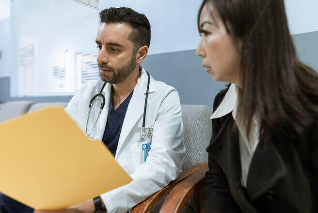 doctor disucussing Medicaid or Medicare forms with a dog bite victim